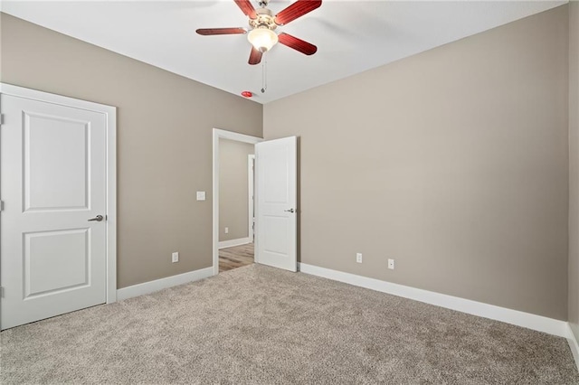 unfurnished bedroom featuring light carpet and ceiling fan