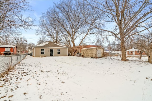 yard covered in snow featuring a storage unit