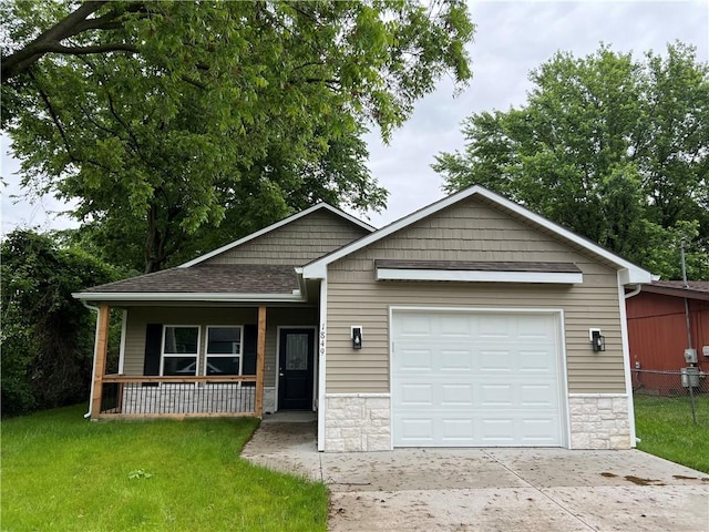 1849 Oneida St, Lexington, MO 64067 - craftsman-style house with stone siding, a porch, concrete driveway, and an attached garage