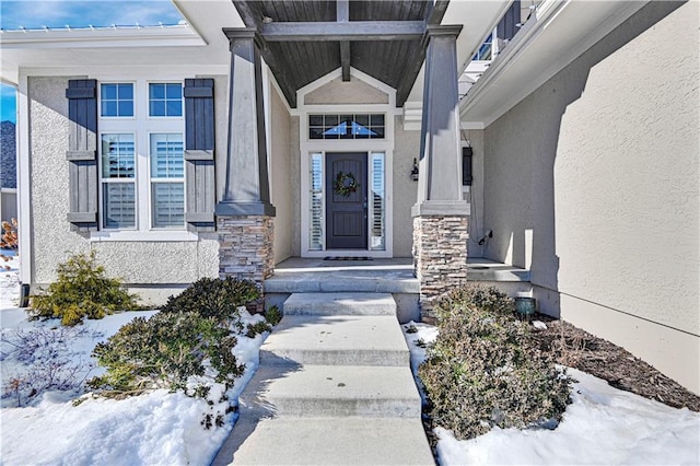 view of snow covered property entrance