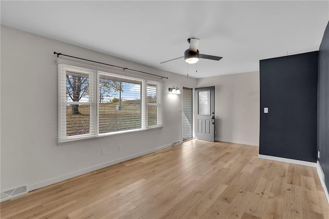 spare room featuring light wood-type flooring and ceiling fan