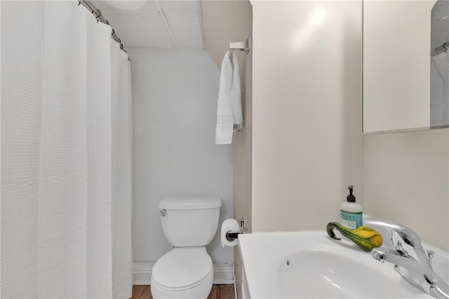 bathroom featuring vanity, a shower with curtain, hardwood / wood-style flooring, and toilet