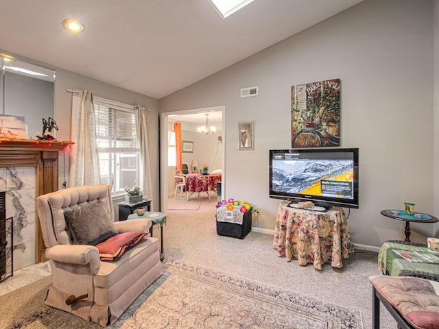 living room featuring a premium fireplace, a chandelier, carpet, and vaulted ceiling