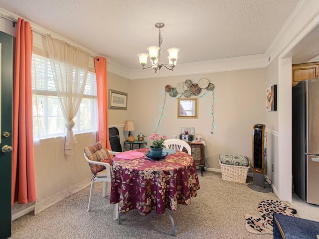 carpeted dining room with crown molding, a textured ceiling, and a chandelier