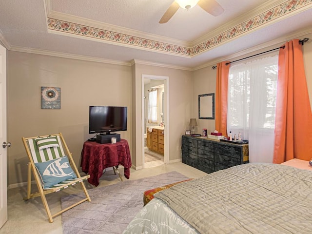 bedroom featuring ensuite bath, crown molding, light colored carpet, and ceiling fan