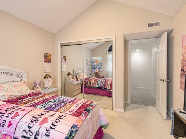 carpeted bedroom with a closet and vaulted ceiling