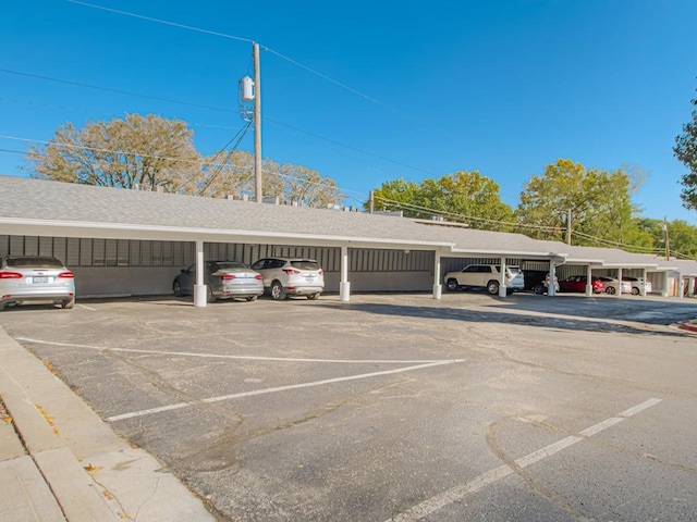 view of parking / parking lot featuring a carport