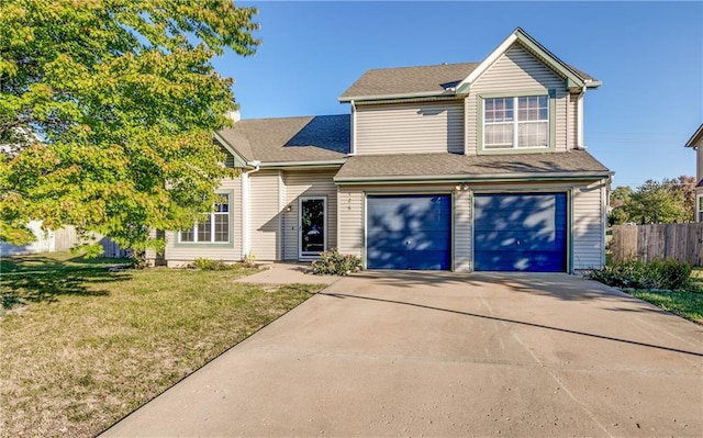 view of front of property featuring a front yard and a garage