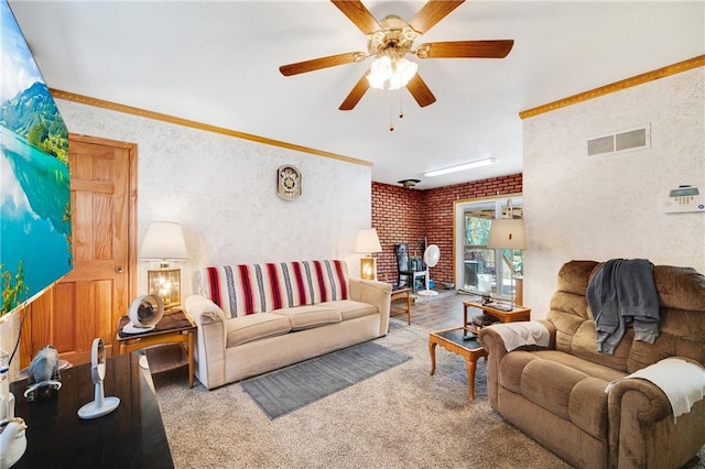 living room featuring ornamental molding, wood-type flooring, a wood stove, and ceiling fan