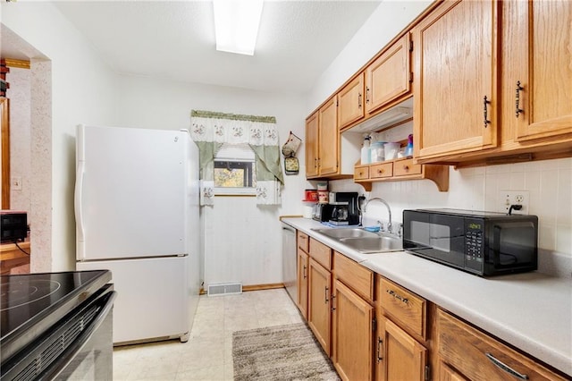 kitchen with sink, light tile patterned flooring, stainless steel dishwasher, decorative backsplash, and white refrigerator