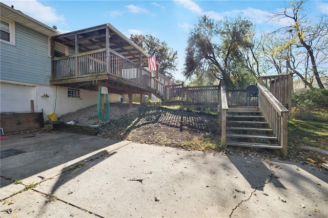 view of yard with a wooden deck and a patio