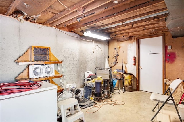 basement featuring white fridge