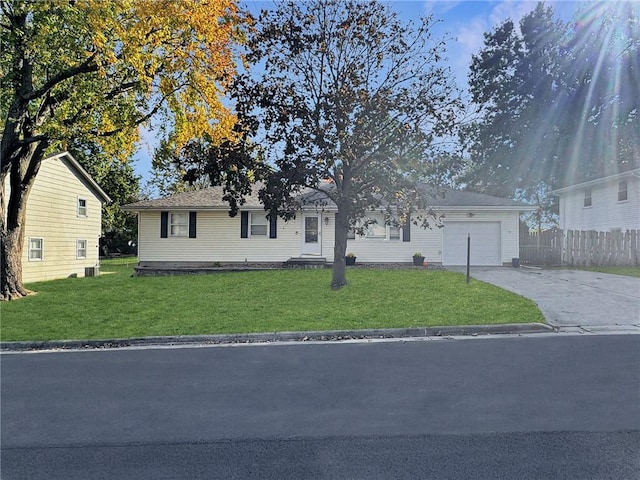 ranch-style home with a garage, central AC unit, and a front yard