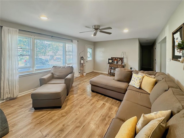 living room with light hardwood / wood-style floors and ceiling fan