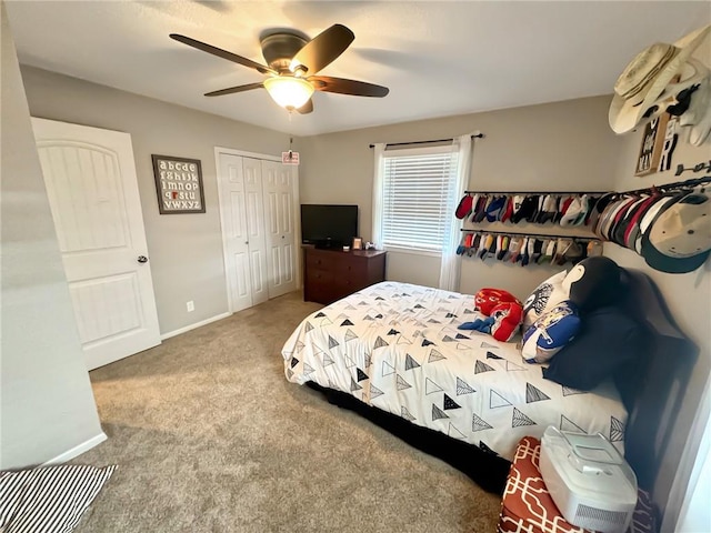 bedroom featuring a closet, ceiling fan, and carpet floors