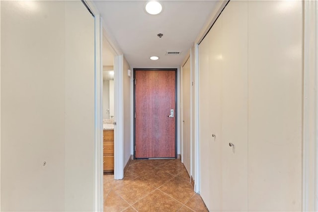 hall featuring light tile patterned floors