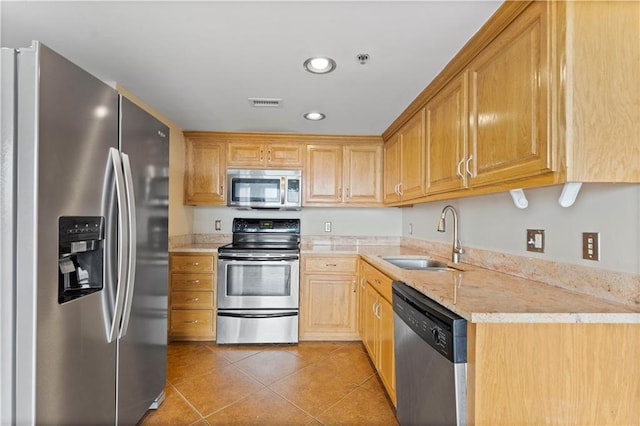 kitchen with stainless steel appliances, a sink, light tile patterned floors, recessed lighting, and light stone counters
