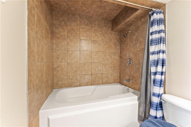 bathroom with toilet and shower / bath combo with shower curtain