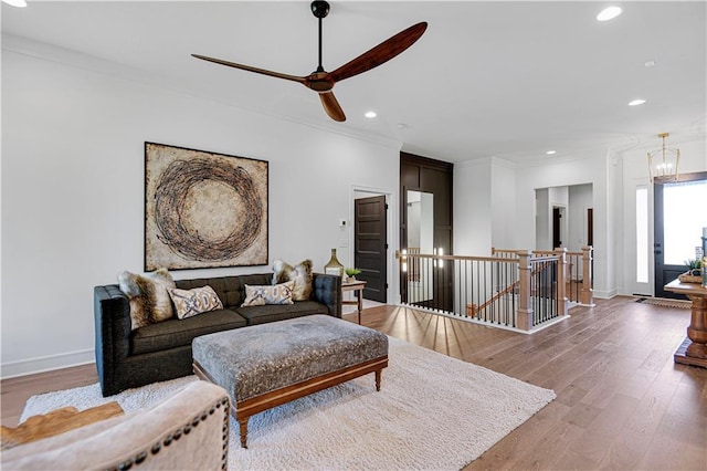 12967 S Constance St, Olathe, KS 66062 - living room with recessed lighting, crown molding, wood finished floors, and a ceiling fan