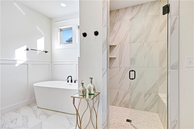 12967 S Constance St, Olathe, KS 66062 - bathroom featuring a shower stall, marble finish floors, a soaking tub, a decorative wall, and a wainscoted wall
