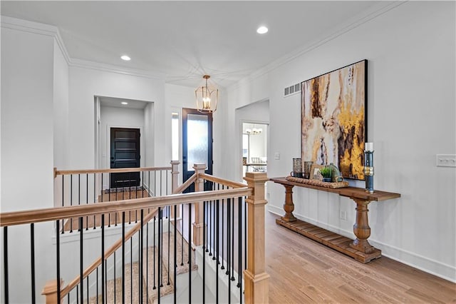 12967 S Constance St, Olathe, KS 66062 - hall featuring an upstairs landing, a chandelier, light wood-style floors, recessed lighting, and ornamental molding