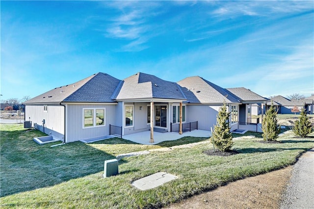 12967 S Constance St, Olathe, KS 66062 - rear view of house with a patio and a lawn