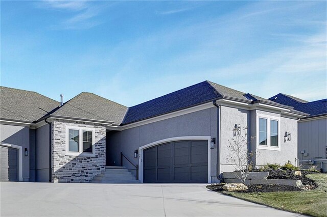 12967 S Constance St, Olathe, KS 66062 - view of front of property featuring a garage, driveway, stucco siding, stone siding, and a shingled roof