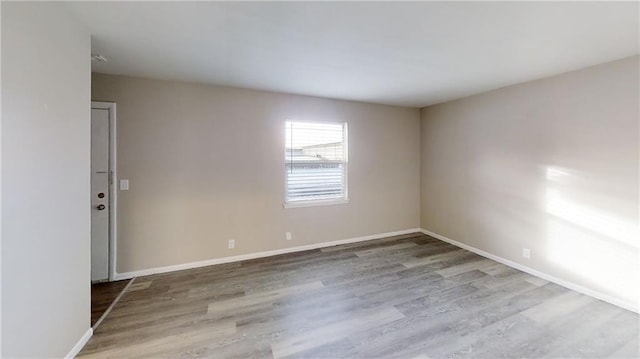 spare room featuring light hardwood / wood-style floors