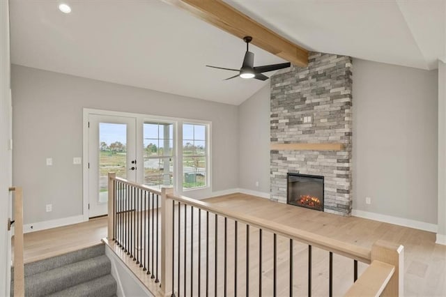unfurnished living room with wood finished floors, ceiling fan, a large fireplace, baseboards, and recessed lighting