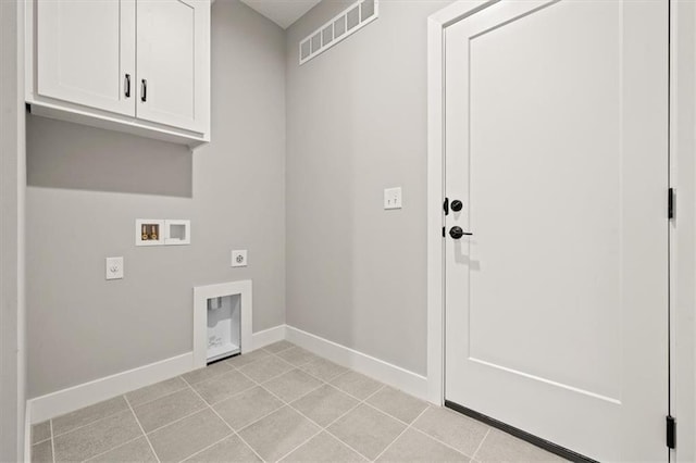 laundry area with cabinet space, hookup for an electric dryer, washer hookup, baseboards, and light tile patterned floors