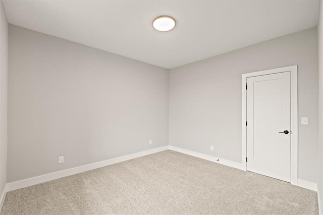 carpeted empty room with baseboards
