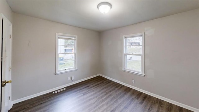 spare room featuring dark wood-type flooring