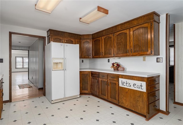 kitchen featuring white fridge with ice dispenser