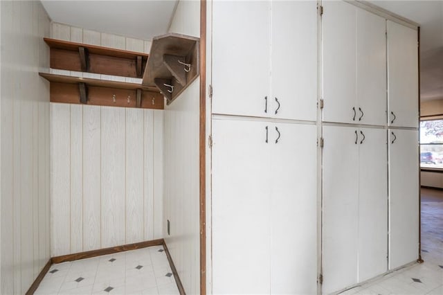 mudroom featuring wooden walls