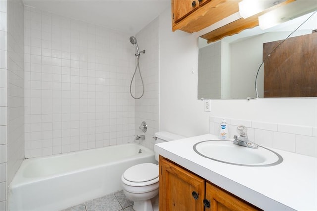 full bathroom featuring toilet, tiled shower / bath, vanity, decorative backsplash, and tile patterned flooring