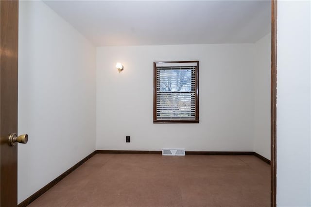 unfurnished room featuring light carpet