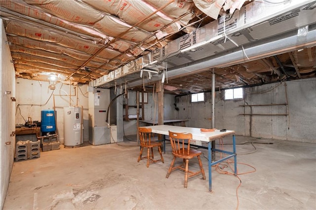 basement featuring heating unit and water heater