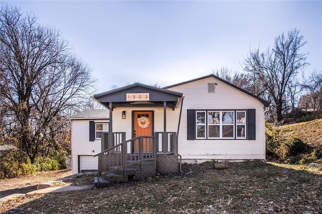 bungalow-style house featuring a garage