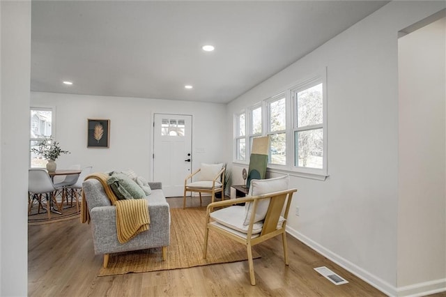 sitting room with hardwood / wood-style flooring