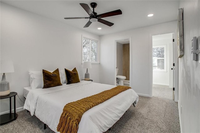 bedroom with carpet floors, ensuite bath, and ceiling fan