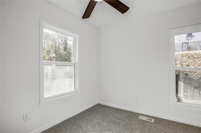 spare room with carpet floors and ceiling fan