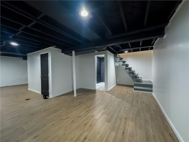 basement with hardwood / wood-style flooring