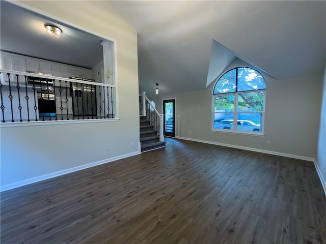 unfurnished living room featuring lofted ceiling and dark hardwood / wood-style floors