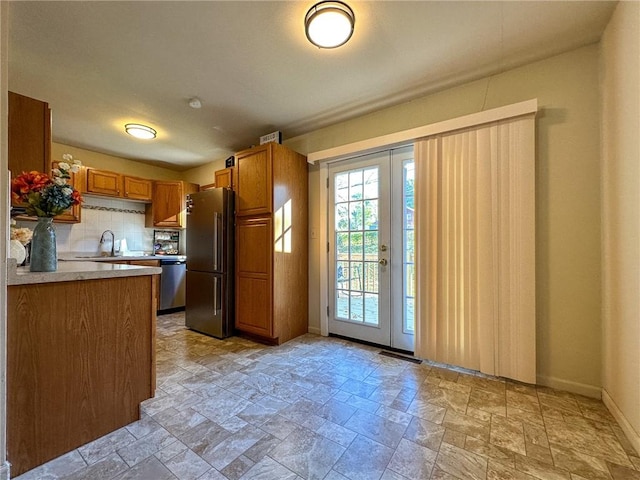 kitchen with decorative backsplash, stainless steel appliances, and sink