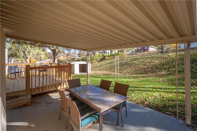 view of patio / terrace with a shed and a deck