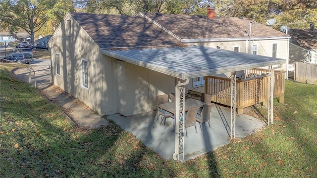 exterior space featuring a deck and a lawn