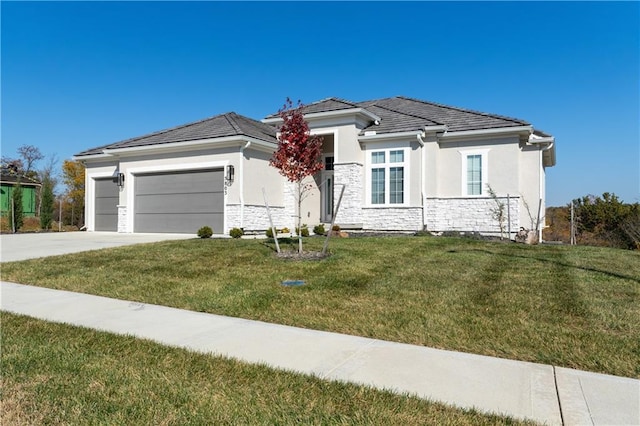 prairie-style home featuring a garage and a front lawn