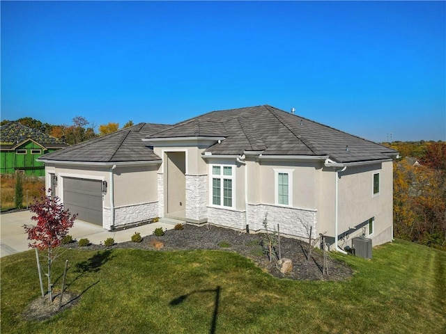 exterior space featuring a garage, a front yard, and central AC unit