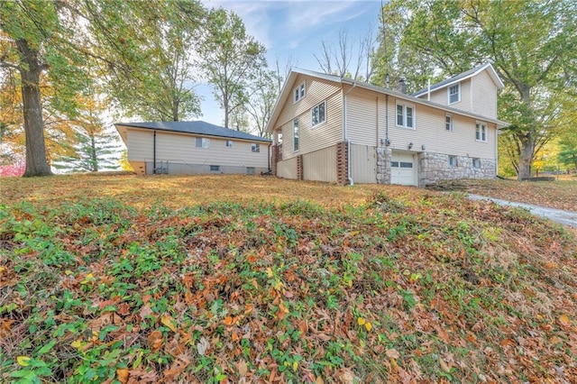 back of property featuring a garage