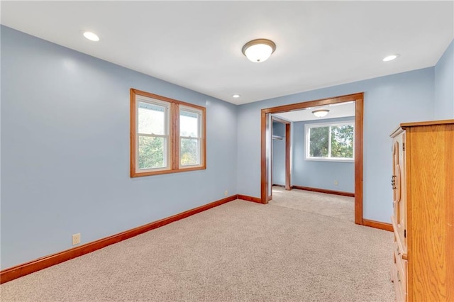 unfurnished room with light carpet and a healthy amount of sunlight